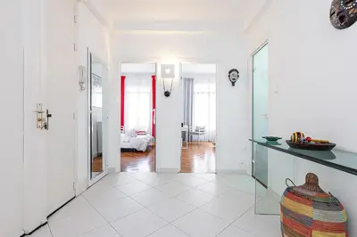 a room with a hallway with white walls and white floors at FEEL HOME - GRIMALDI in Nice