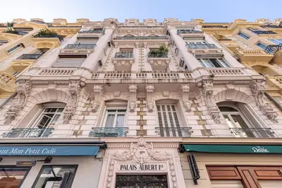a tall building with windows and a sign on it at FEEL HOME - GRIMALDI in Nice