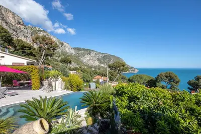 a resort with a swimming pool and the ocean at Villa Panorama in Èze