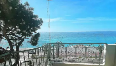 a view of the ocean from a balcony of a beach at Holiday Vigie Promenade in Nice