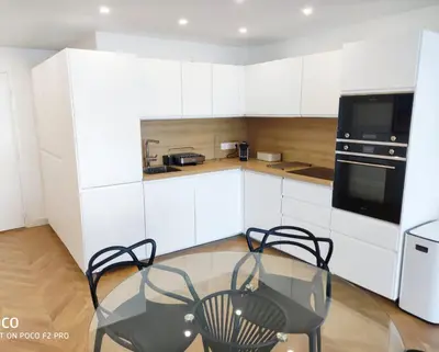 a kitchen with a glass table and two chairs at Holiday Vigie Promenade in Nice
