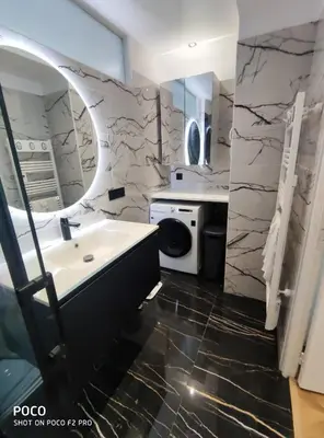 a bathroom with a sink and a washing machine at Holiday Vigie Promenade in Nice