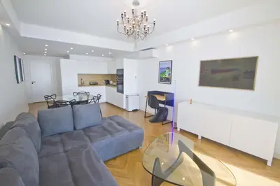 a living room with a couch and a table at Holiday Vigie Promenade in Nice
