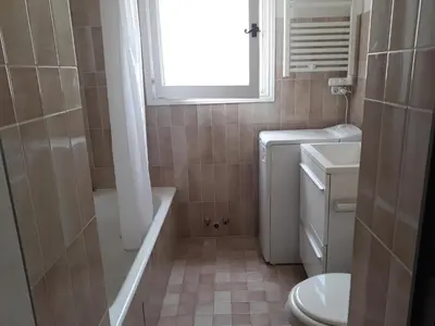 a bathroom with a tub and a toilet and a window at Beauty in Saint-Jean-Cap-Ferrat