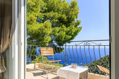 a view of the ocean from the balcony of a house at Sea View Apartment with Private Secure Parking 1 in Villefranche-sur-Mer