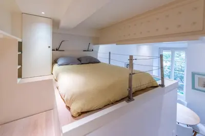 a bedroom with a bed in a white room at Happyfew Liberty in Nice