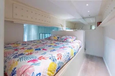 a bedroom with a bed with a colorful comforter at Happyfew Liberty in Nice