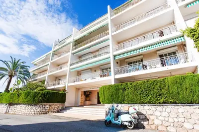 a scooter parked in front of a building at Terrace on the Bay 2 Villefranche-sur-Mer, AP4243 by Riviera Holiday Homes in Villefranche-sur-Mer