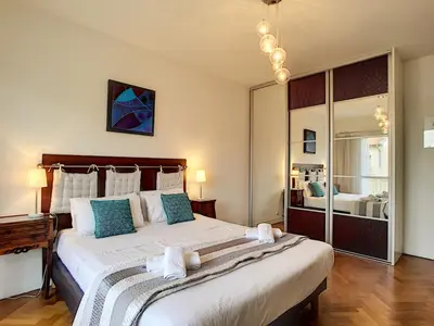 a bedroom with a large bed with blue pillows at Nestor&Jeeves - ANDRIOLI TERRASSE - Central - Close beach - Top floor in Nice