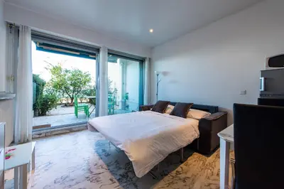 a bedroom with a bed and a large window at Happyfew Eros in Nice