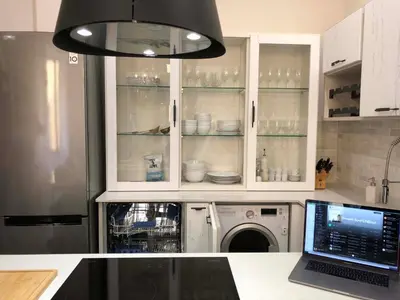 a kitchen with a dishwasher and a laptop on a counter at Petit Palace in Old Nice in Nice
