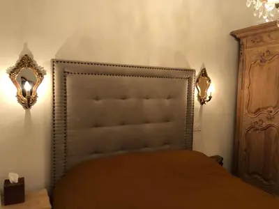 a bedroom with a bed and two mirrors on the wall at Petit Palace in Old Nice in Nice
