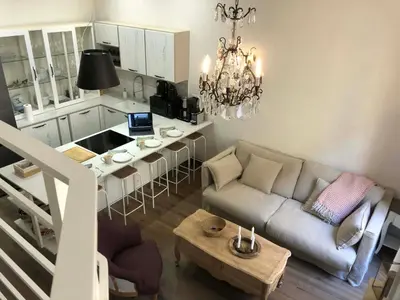 a living room with a couch and a table at Petit Palace in Old Nice in Nice