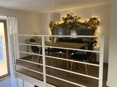 a dining room with a table and a mirror at Petit Palace in Old Nice in Nice