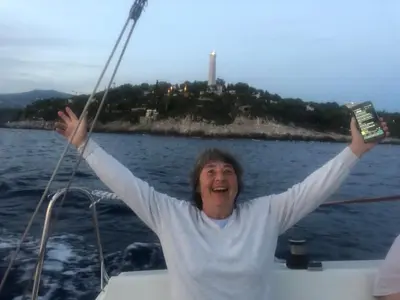 a woman on a boat with her arms in the air at Great and light private room in the heart of Nice in Nice