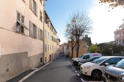 a street with cars parked on the side of a building at Maison Bianchi - Villefranche in Villefranche-sur-Mer