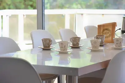a table with cups on it with white chairs at Le Syrius in Nice