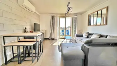 a living room with a couch and a table at L'Avenir du Ray in Nice