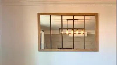 a mirror hanging on a wall with a chandelier at L'Avenir du Ray in Nice