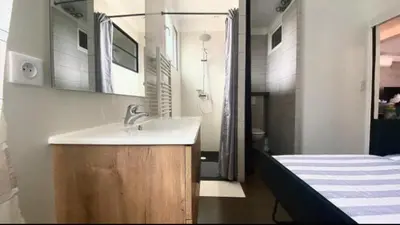 a bathroom with a sink and a bed at L'Avenir du Ray in Nice