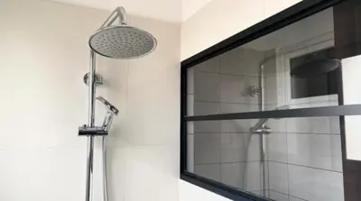 a bathroom with a shower with a mirror and a shower at L'Avenir du Ray in Nice