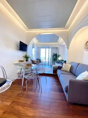 a living room with a couch and a table at LE ROCAMARE -Superb-Atypical Sea view-A.C-WIFI in Nice