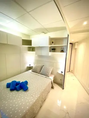 a bedroom with a bed with blue bows on it at LE ROCAMARE -Superb-Atypical Sea view-A.C-WIFI in Nice