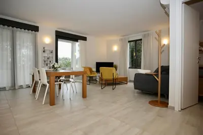 a dining room and living room with a table and chairs at Villa LE CIEL D EZE in Èze
