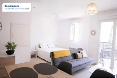 a living room with a bed and a couch at Anicesleep Superbe appart au calme et à 5 mn de la Prom in Nice