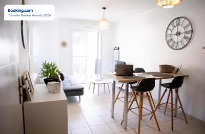 a kitchen with a table and chairs in a room at Anicesleep Superbe appart au calme et à 5 mn de la Prom in Nice
