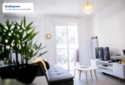 a living room with a blue couch and a table at Anicesleep Superbe appart au calme et à 5 mn de la Prom in Nice