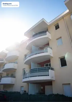 a building with balconies on the side of it at Anicesleep Superbe appart au calme et à 5 mn de la Prom in Nice