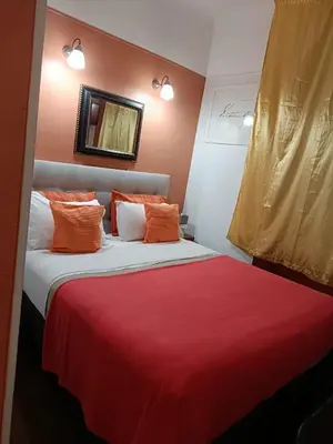 a bedroom with a bed with red and purple at Hotel Villa La Tour in Nice