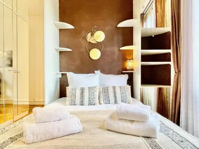 a bedroom with a bed with two towels on it at Swiss Star - Easy Home Booking in Nice