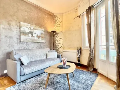 a living room with a couch and a table at Swiss Star - Easy Home Booking in Nice