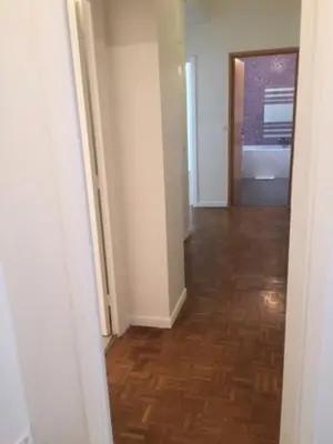 an empty room with a hallway with a wooden floor at BIG WHITE in Nice