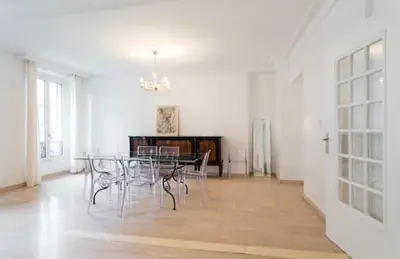 a dining room with a table and chairs at BIG WHITE in Nice