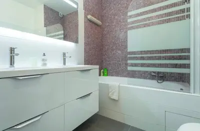 a white bathroom with a tub and a sink and a mirror at BIG WHITE in Nice