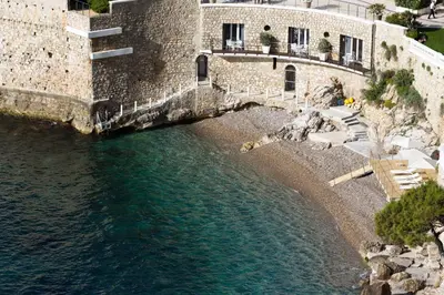 an aerial view of a body of water next to a building at Hotel Cap Estel in Èze