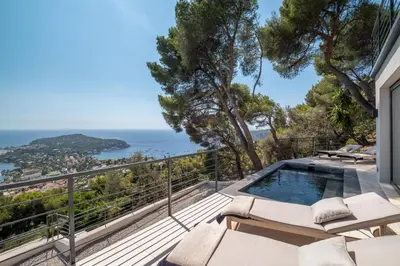 a balcony with a pool and a view of the ocean at Villa Vista Mare by iVillamia com in Villefranche-sur-Mer