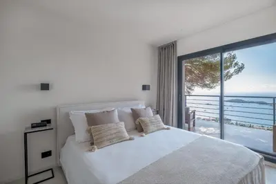 a bedroom with a bed with a view of the ocean at Villa Vista Mare by iVillamia com in Villefranche-sur-Mer