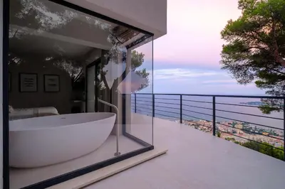 a bathroom with a bath tub on a balcony at Villa Vista Mare by iVillamia com in Villefranche-sur-Mer
