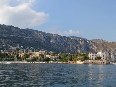 a view of a city from the water with mountains at Studette 