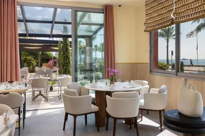 a hotel room with a large bed and a balcony at Hotel Royalmar in Cagnes-sur-Mer