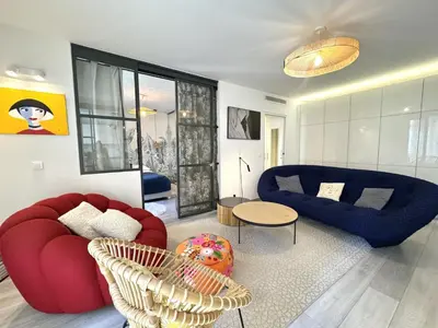 a living room with two red chairs and a blue couch at ApartHotel Riviera - Terrasse Loft de la Providence - Vieille Ville - Esprit Loft en 2 pices AC in Nice