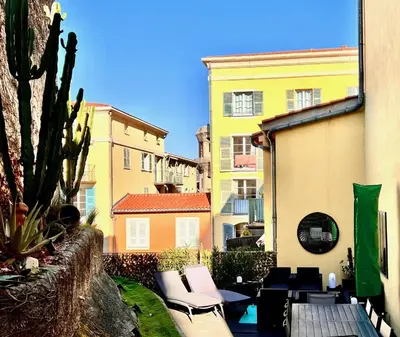 a view of a patio with chairs and buildings at ApartHotel Riviera - Terrasse Loft de la Providence - Vieille Ville - Esprit Loft en 2 pices AC in Nice
