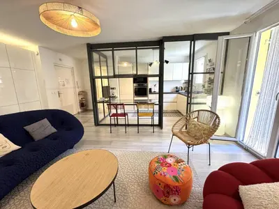 a living room with a blue couch and a table at ApartHotel Riviera - Terrasse Loft de la Providence - Vieille Ville - Esprit Loft en 2 pices AC in Nice
