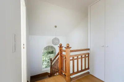 a staircase in a home with white walls at Villa Élégante Nice avec Vue Mer in Nice