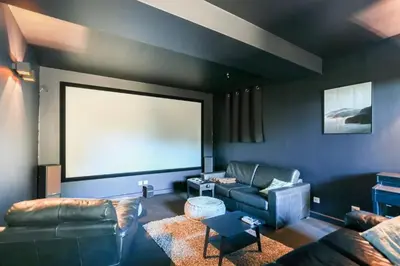 a living room with a couch and a screen at Villa Élégante Nice avec Vue Mer in Nice