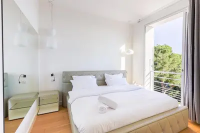 a bedroom with two beds and a large window at Villa Élégante Nice avec Vue Mer in Nice
